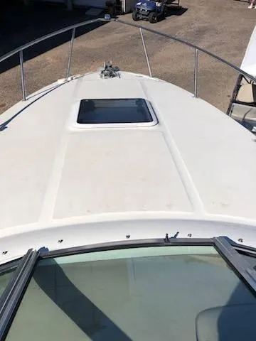 Slide: The Image of 2001 Sea Ray 260DA boat deck with hatch, railing, and clear sky view. - 7