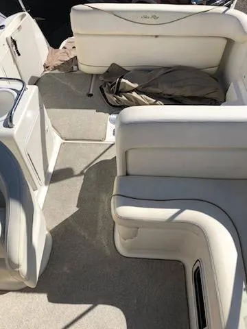 Slide: The Image of 2001 Sea Ray 260DA boat interior with white seating and carpeted floor. - 9