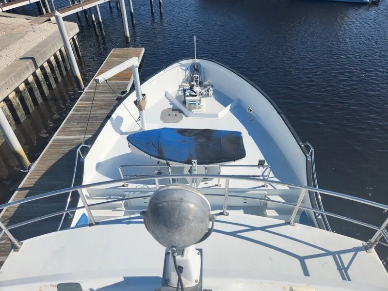 Slide: The Image of 1983 Custom 76 Trawler docked, view from bow, calm water, sunny day. - 22