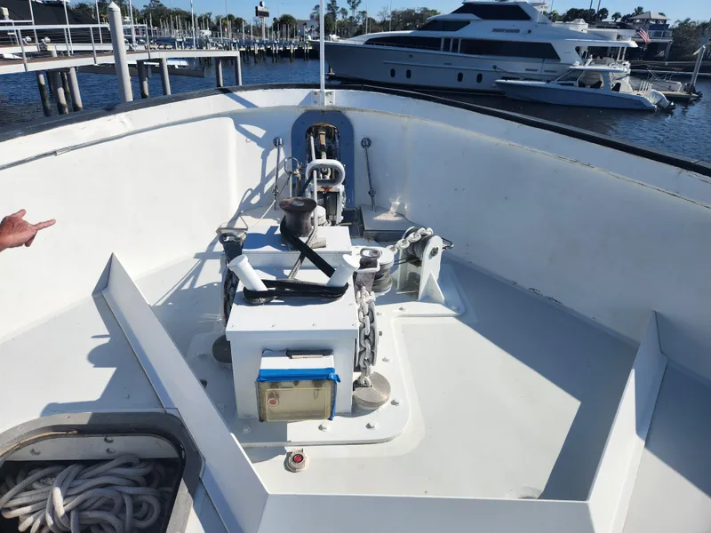 Slide: The Image of Bow of 1983 Custom 76 Trawler with anchor equipment, docked at marina. - 24
