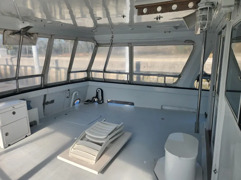 Slide: The Image of Interior of 1983 Custom 76 Trawler with spacious seating and panoramic windows. - 28