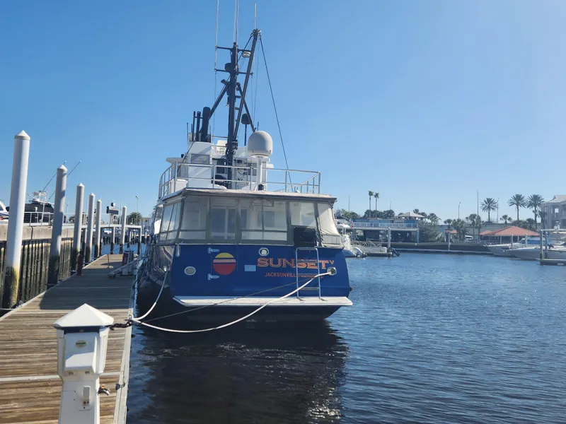 Slide: The Image of Custom 76 Trawler, 1983 model, docked at marina under clear blue sky. - 3
