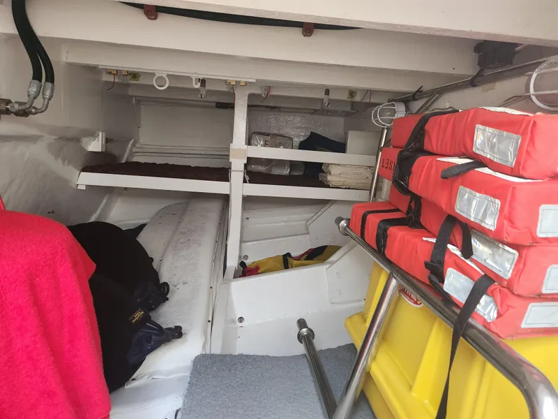 Slide: The Image of Interior of 1983 Custom 76 Trawler with life jackets and storage compartments. - 32