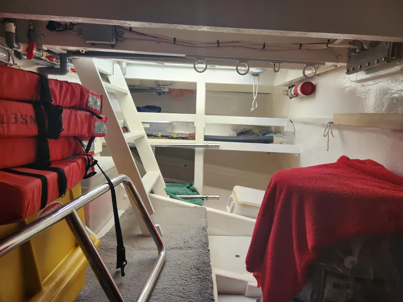 Slide: The Image of Interior of 1983 Custom 76 Trawler with life jackets and storage shelves. - 33