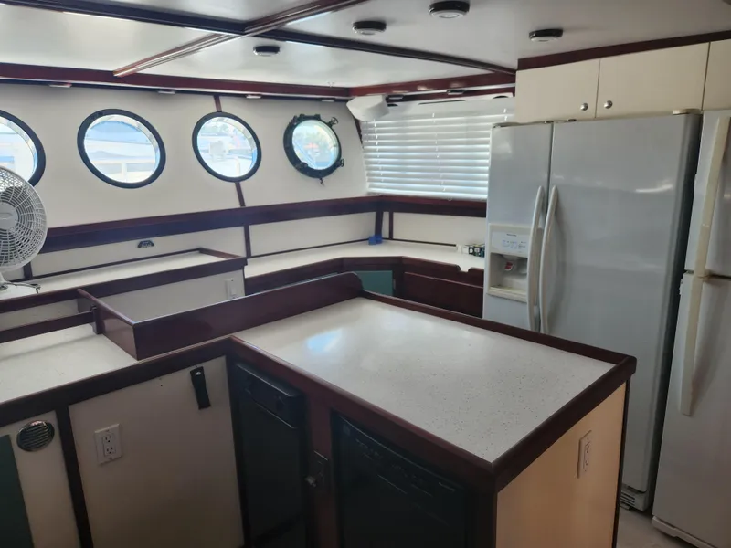 Slide: The Image of Interior of 1983 Custom 76 Trawler with modern kitchen and porthole windows. - 36