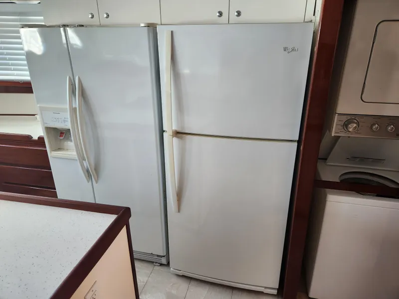 Slide: The Image of Two white refrigerators in a 1983 Custom 76 Trawler kitchen area. - 37