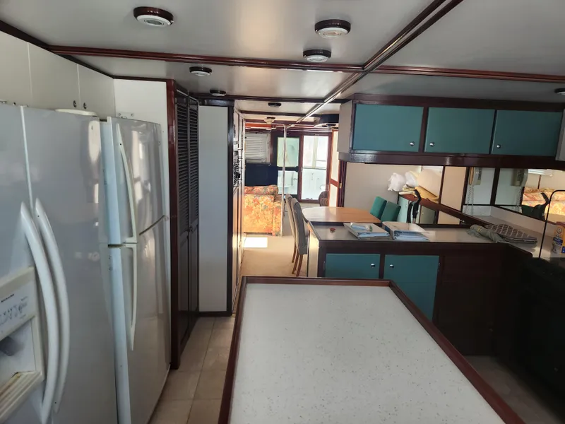 Slide: The Image of Interior of 1983 Custom 76 Trawler with spacious kitchen and dining area. - 38