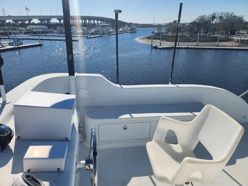 Slide: The Image of Flybridge view from 1983 Custom 76 Trawler overlooking marina and bridge on a sunny day. - 8