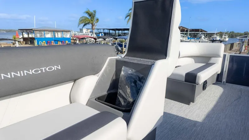 Slide: The Image of 2025 Bennington 20 SL boat interior with open storage compartment, dockside view. - 10