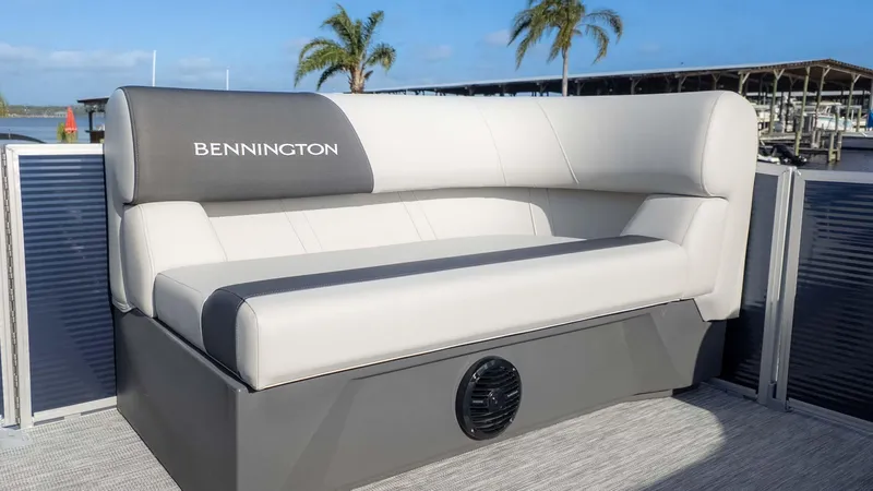 Slide: The Image of 2025 Bennington 20 SL boat seat with sleek design, dockside view, and palm trees in background. - 11