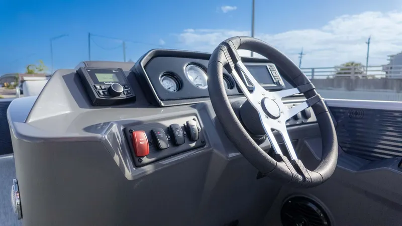 Slide: The Image of Steering console of 2025 Bennington 20 SL boat with modern controls and gauges. - 18