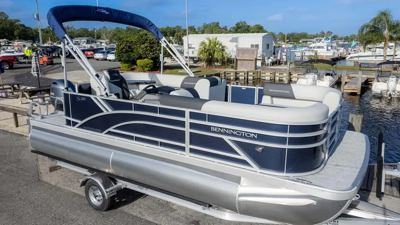 Slide: The Image of 2025 Bennington 20 SL pontoon boat on trailer at marina. - 3