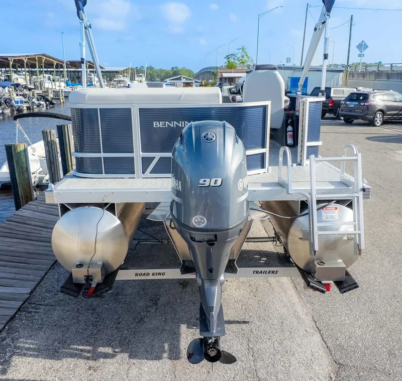 Slide: The Image of 2025 Bennington 20 SL pontoon boat with Yamaha 90 engine at a marina dock. - 5