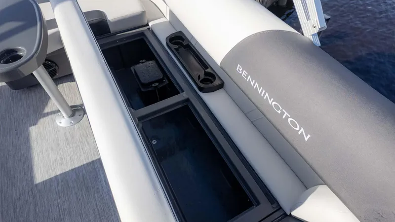 Slide: The Image of 2025 Bennington 20 SL boat interior with storage compartment and cup holders. - 9
