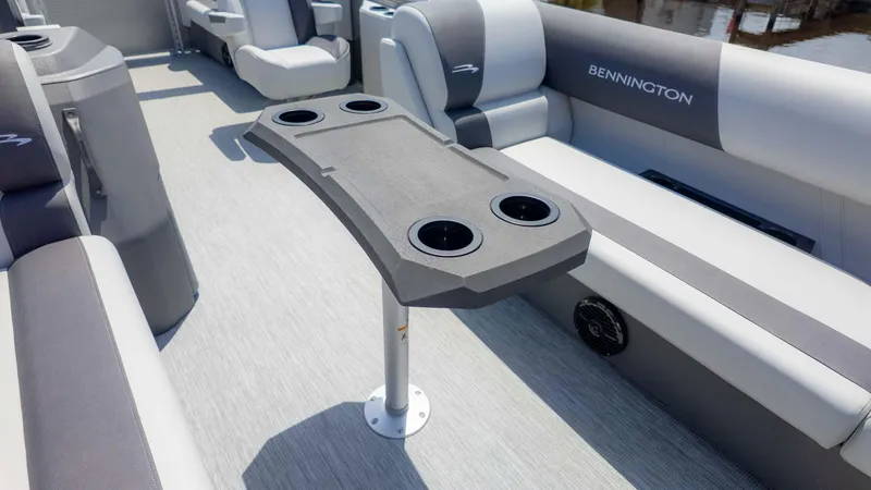 Slide: The Image of 2025 Bennington 20SSRSE pontoon boat interior with cup holders and seating. - 10