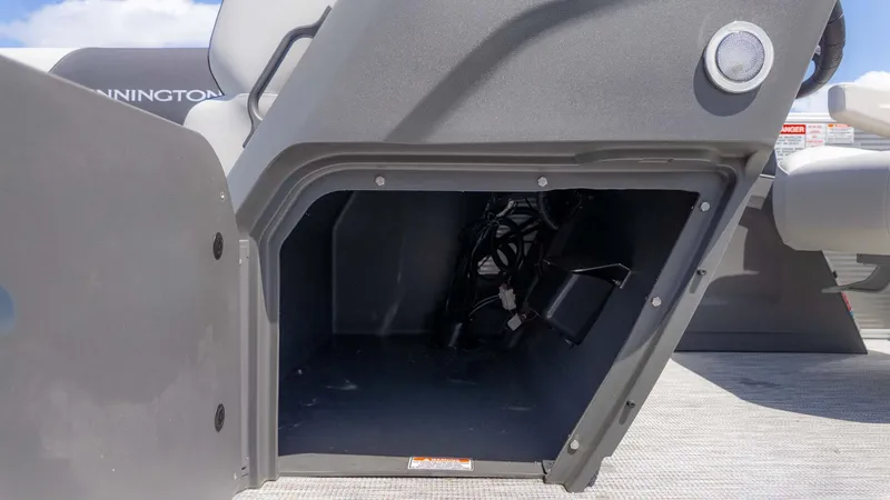 Slide: The Image of Open storage compartment on a 2025 Bennington 20SSRSE boat, showing interior wiring. - 15