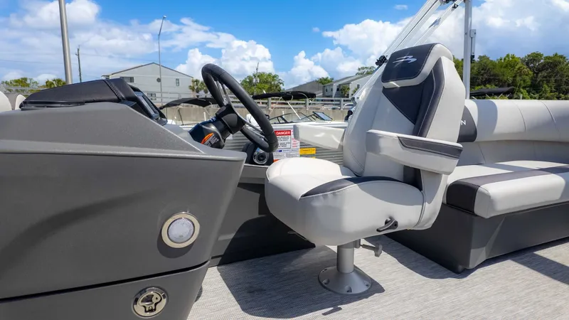 Slide: The Image of 2025 Bennington 20SSRSE boat interior with steering wheel and captain's chair. - 16