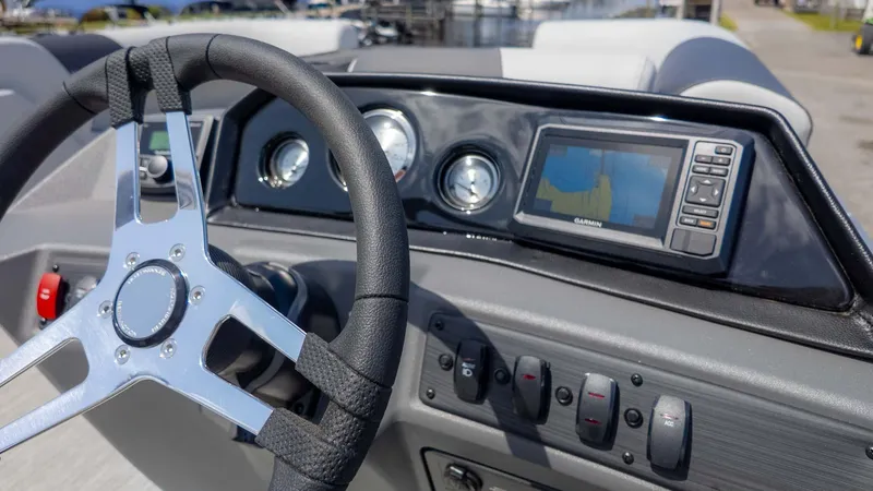 Slide: The Image of 2025 Bennington 20SSRSE boat dashboard with steering wheel and Garmin navigation system. - 19