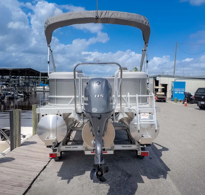 Slide: The Image of 2025 Bennington 20SSRSE pontoon boat with Yamaha 115 engine at dockside. - 5
