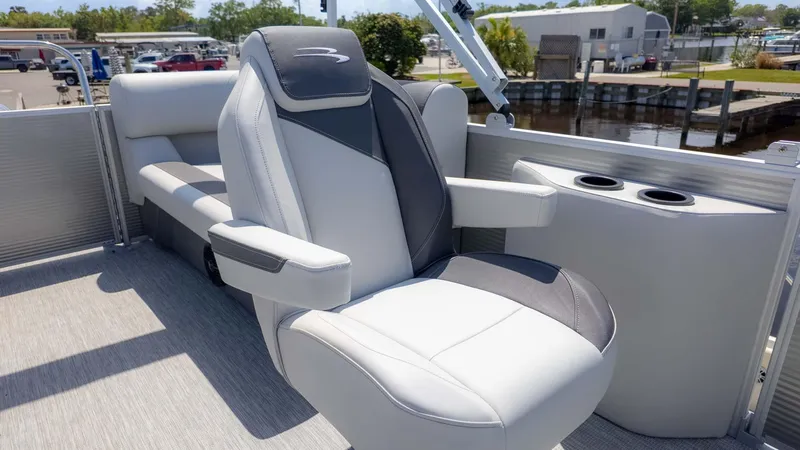 Slide: The Image of 2025 Bennington 20SSRSE boat interior with luxurious seating and cup holders. - 9
