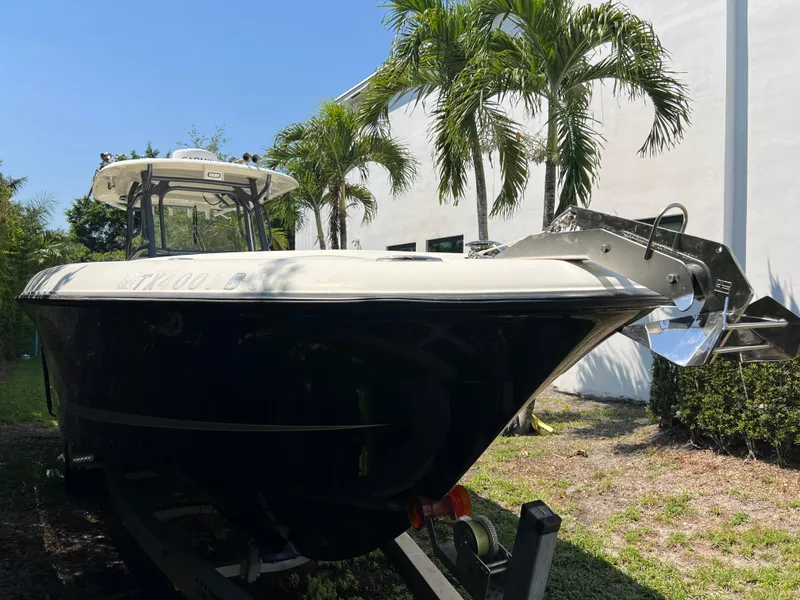 Slide: The Image of 2012 Hydra-Sports 3400 CC boat on trailer, surrounded by palm trees. - 16