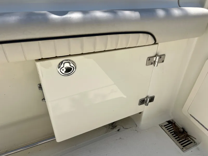 Slide: The Image of 2012 Hydra-Sports 3400 CC boat storage compartment with chrome handle and hinges. - 24