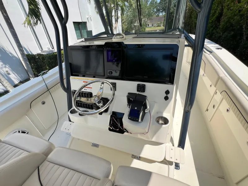Slide: The Image of 2012 Hydra-Sports 3400 CC boat cockpit with steering wheel and navigation equipment. - 30