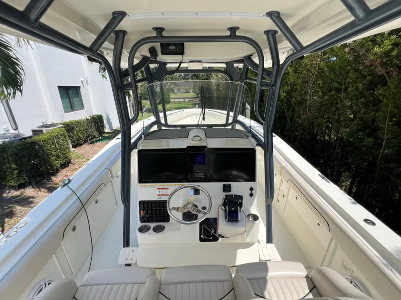 Slide: The Image of 2012 Hydra-Sports 3400 CC boat cockpit with steering wheel and control panel. - 34