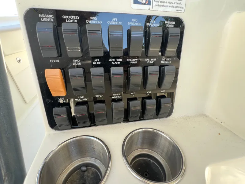 Slide: The Image of Control panel of a 2012 Hydra-Sports 3400 CC boat with labeled switches. - 35
