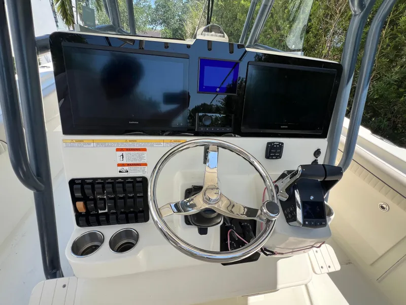 Slide: The Image of 2012 Hydra-Sports 3400 CC boat dashboard with dual screens and steering wheel. - 36