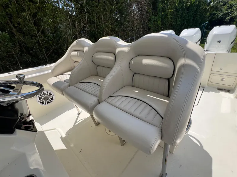 Slide: The Image of 2012 Hydra-Sports 3400 CC boat with white cushioned seats and steering wheel. - 37