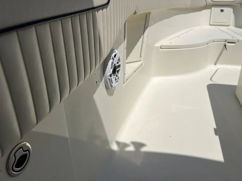 Slide: The Image of 2012 Hydra-Sports 3400 CC boat interior with white seating and speaker detail. - 45