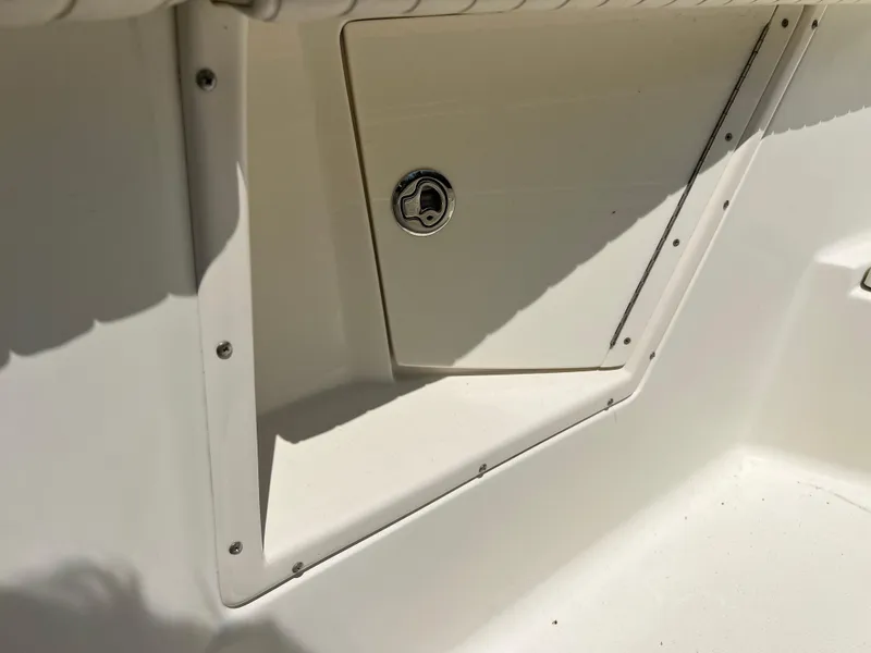 Slide: The Image of 2012 Hydra-Sports 3400 CC boat storage compartment with secure latch. - 47