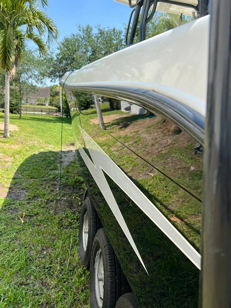 Slide: The Image of 2012 Hydra-Sports 3400 CC boat side view with sleek design and glossy finish. - 5