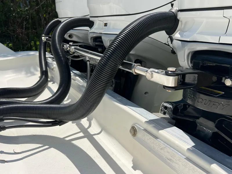 Slide: The Image of 2012 Hydra-Sports 3400 CC boat engine components with hydraulic hoses and mounting hardware. - 8