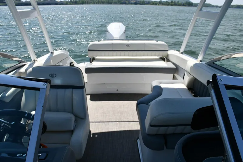 Slide: The Image of 2019 Cobalt 25SC boat interior with seating, on a sunny lake. - 10