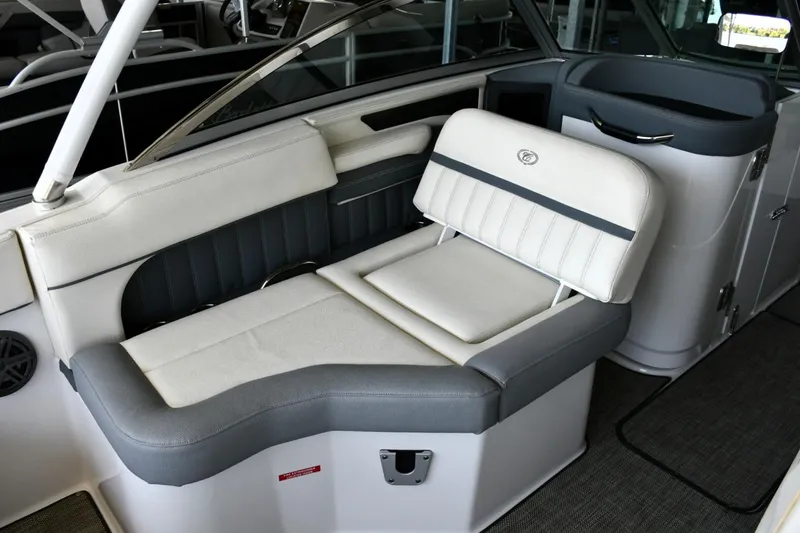 Slide: The Image of 2019 Cobalt 25SC boat interior with cushioned seating and sleek design. - 11
