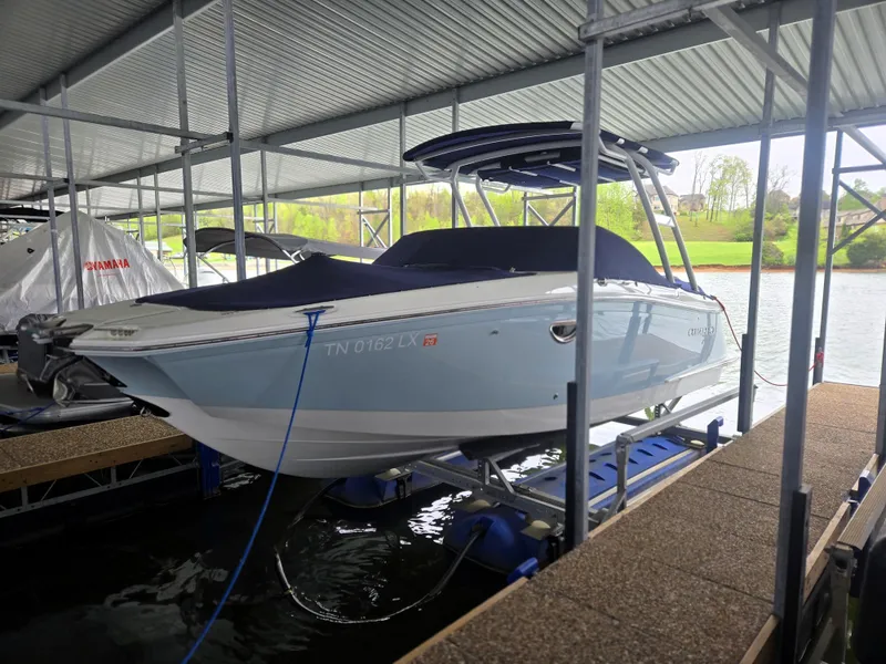Slide: The Image of 2019 Cobalt 25SC boat docked in a covered marina, side view. - 12