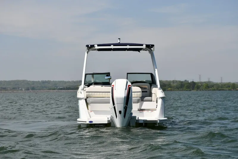 Slide: The Image of 2019 Cobalt 25SC boat on water, rear view with open deck and outboard motor. - 4