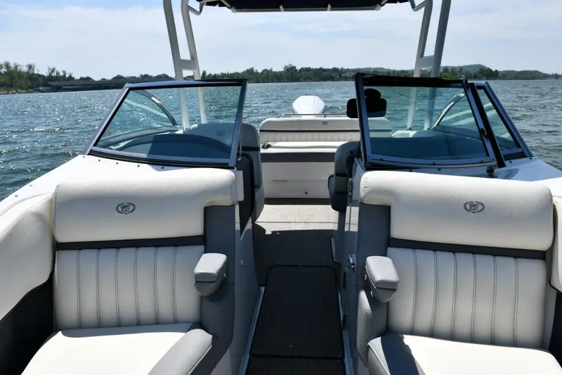 Slide: The Image of 2019 Cobalt 25SC boat interior with white seating on a sunny day. - 9