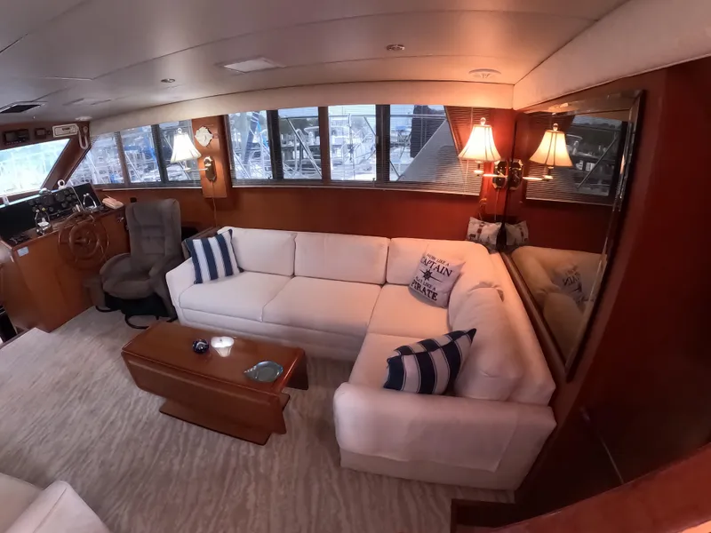 Slide: The Image of Luxurious interior of a 1995 Jefferson 48 Rivanna yacht with white seating and nautical decor. - 14