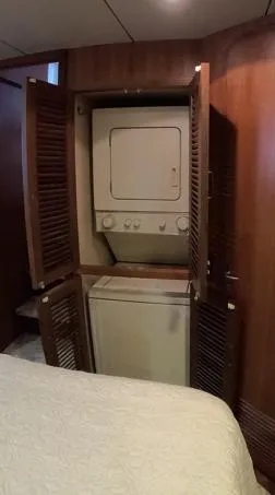 Slide: The Image of Laundry area inside 1995 Jefferson 48 Rivanna yacht with stacked washer and dryer. - 16