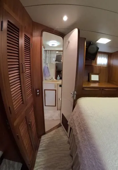 Slide: The Image of Interior of 1995 Jefferson 48 Rivanna yacht, featuring wood paneling and cozy bedroom. - 17