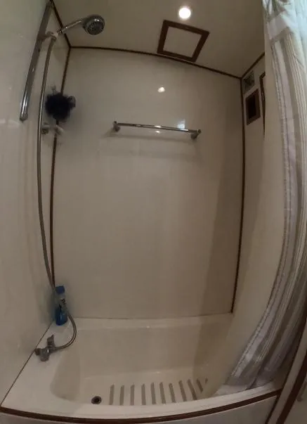 Slide: The Image of Shower area in a 1995 Jefferson 48 Rivanna yacht, featuring a curtain and showerhead. - 19