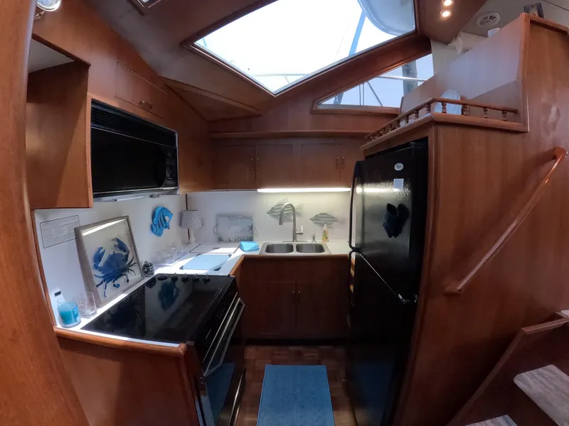 Slide: The Image of Interior of 1995 Jefferson 48 Rivanna yacht kitchen with wood cabinetry and modern appliances. - 20