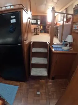 Slide: The Image of Interior of 1995 Jefferson 48 Rivanna yacht with wooden stairs and compact kitchen area. - 22