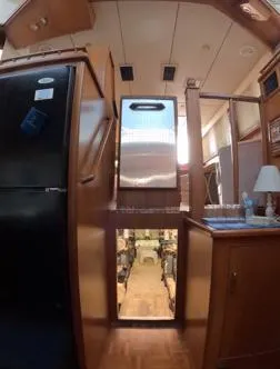 Slide: The Image of Interior of a 1995 Jefferson 48 Rivanna yacht, featuring kitchen appliances and wooden cabinetry. - 23