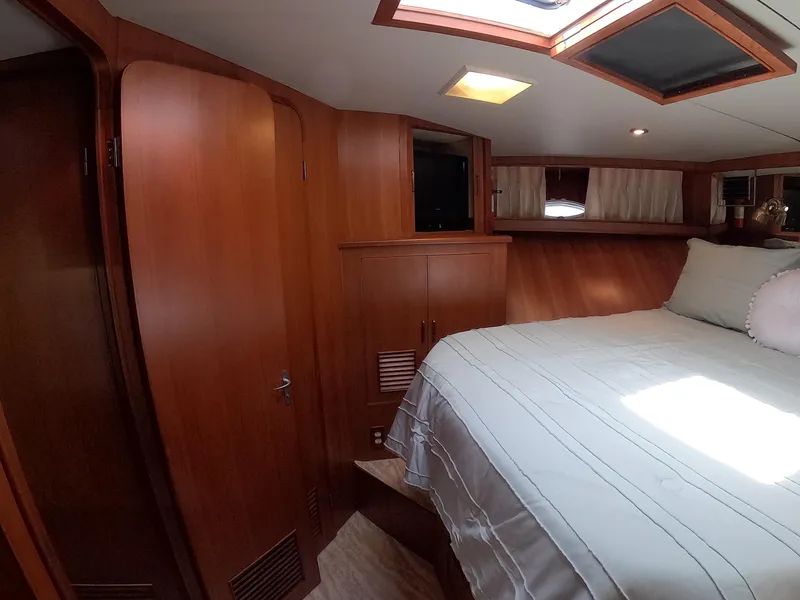 Slide: The Image of Cozy bedroom interior of 1995 Jefferson 48 Rivanna yacht with wooden cabinetry and skylight. - 27