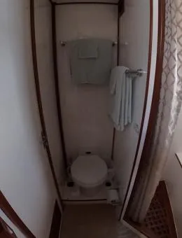 Slide: The Image of Compact bathroom in a 1995 Jefferson 48 Rivanna yacht with toilet and towels. - 29