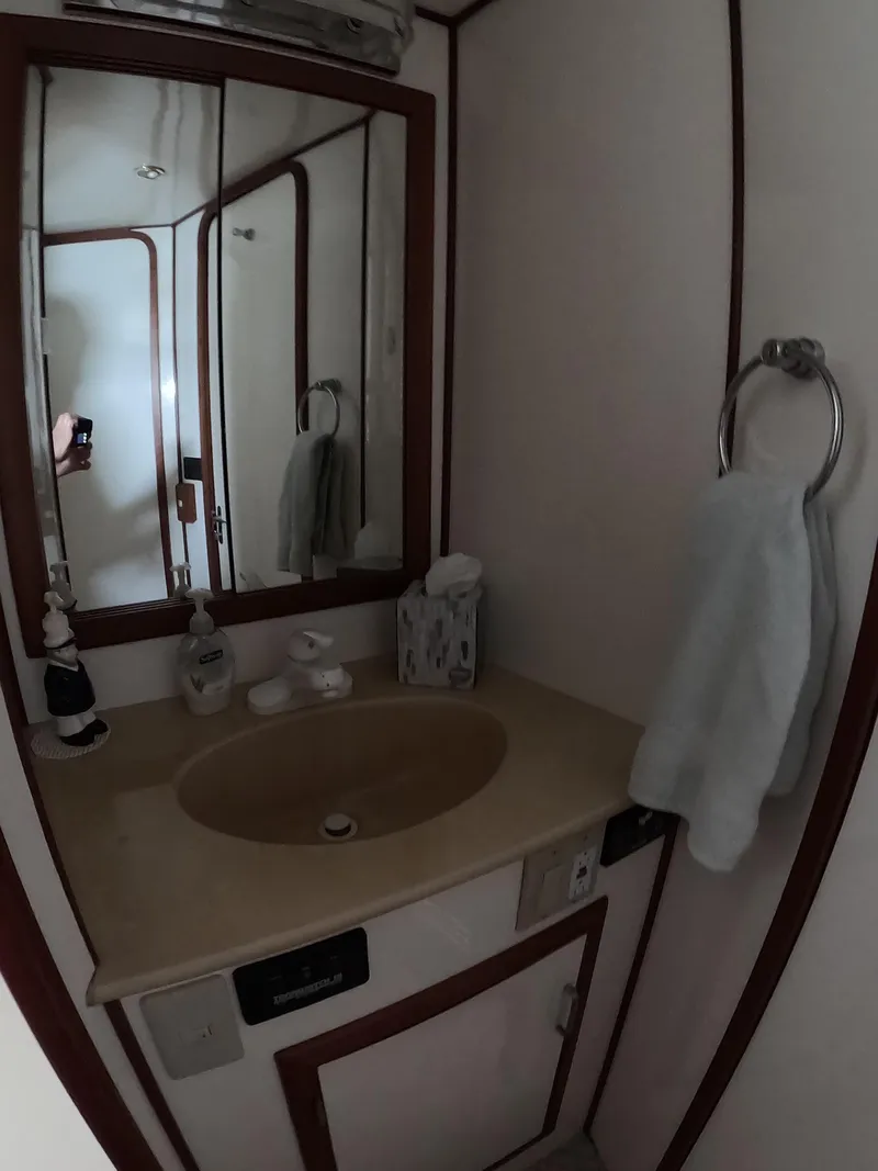 Slide: The Image of Bathroom interior of a 1995 Jefferson 48 Rivanna yacht with sink and mirror. - 31